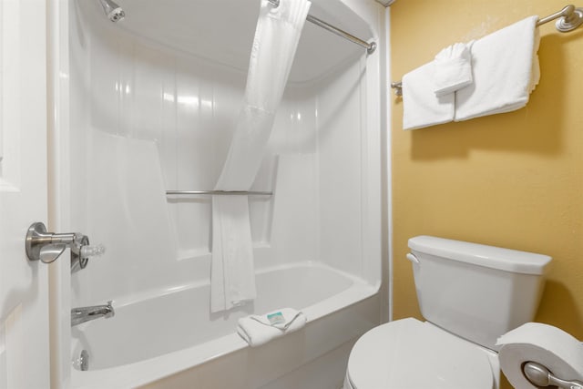 bathroom featuring shower / bath combo and toilet