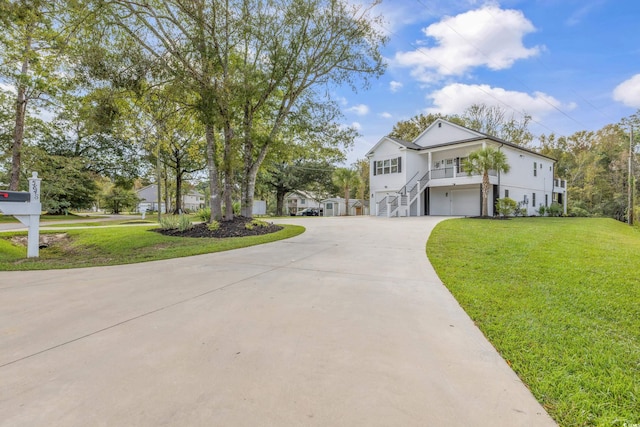 view of front of home with a garage and a front lawn