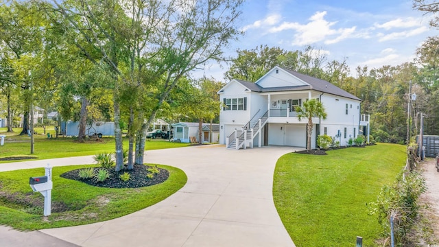 view of front of home with a front yard and a garage