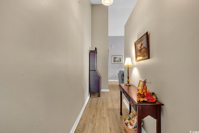 corridor with light hardwood / wood-style flooring