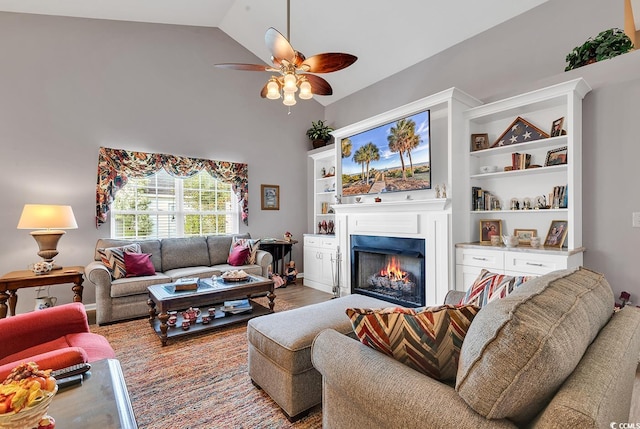 living room featuring wood-type flooring, high vaulted ceiling, and ceiling fan