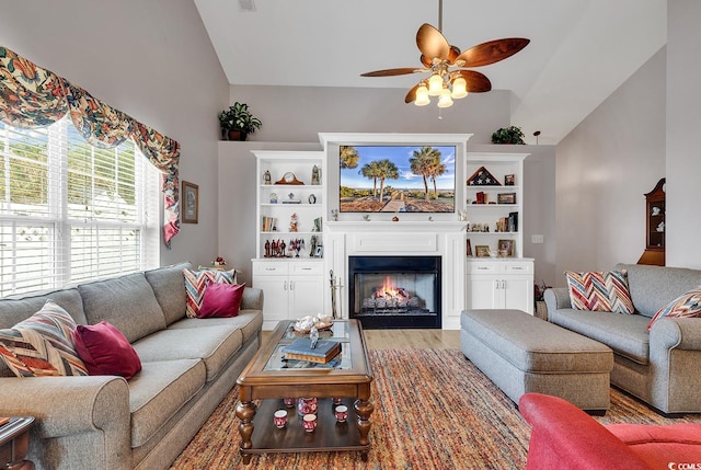 living room with ceiling fan, vaulted ceiling, and wood-type flooring