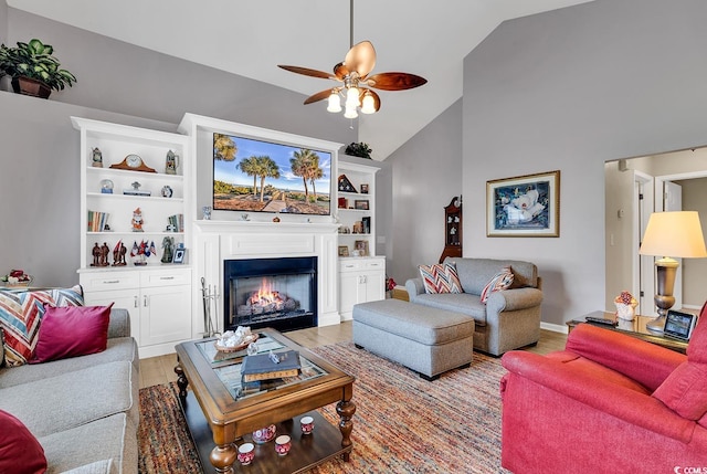 living room with high vaulted ceiling, light wood-type flooring, and ceiling fan