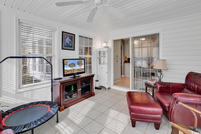 tiled living room with wood walls and ceiling fan