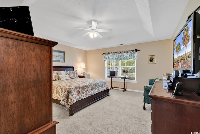 carpeted bedroom with ceiling fan and a textured ceiling