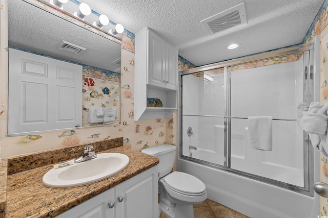 full bathroom with vanity, a textured ceiling, enclosed tub / shower combo, tile patterned flooring, and toilet