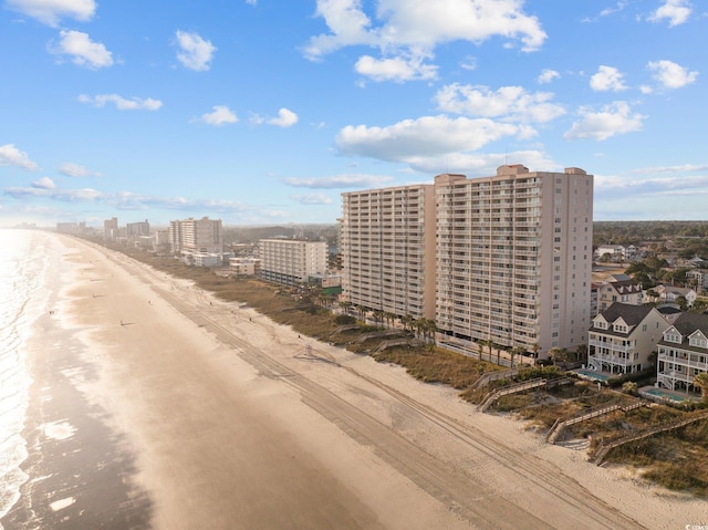 drone / aerial view with a water view and a beach view