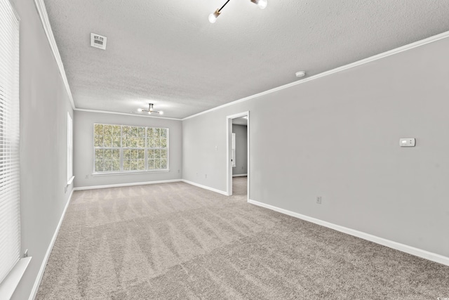 empty room featuring crown molding, a textured ceiling, and carpet floors