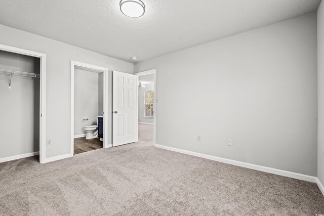 4273 Villas Dr Unit 1007, Little River, SC 29566 - unfurnished bedroom featuring carpet floors, a textured ceiling, baseboards, and a closet
