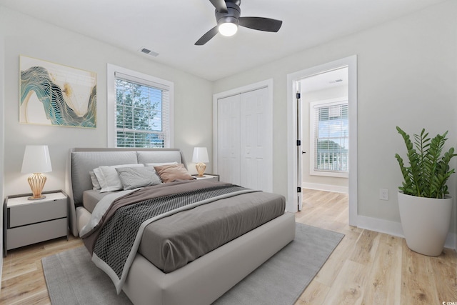 bedroom featuring ceiling fan, a closet, and light hardwood / wood-style floors