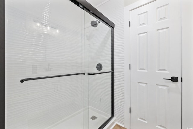 bathroom featuring a shower with shower door