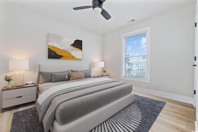 bedroom with ceiling fan and light hardwood / wood-style flooring