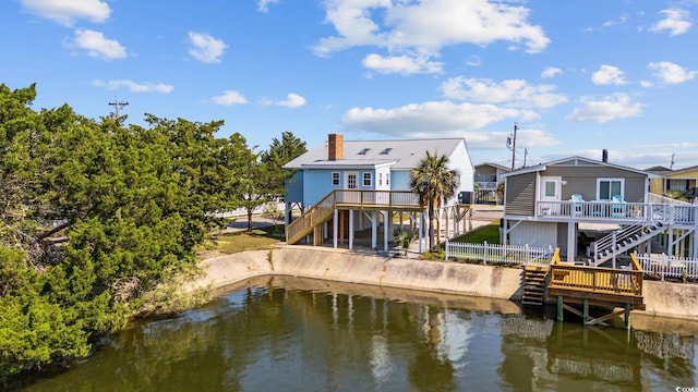 back of house with a deck with water view