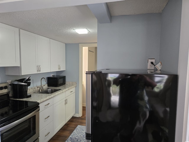 kitchen featuring dark wood-type flooring, sink, white cabinets, and black appliances