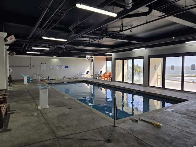 view of pool with a water view