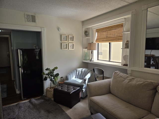 carpeted living room with a textured ceiling