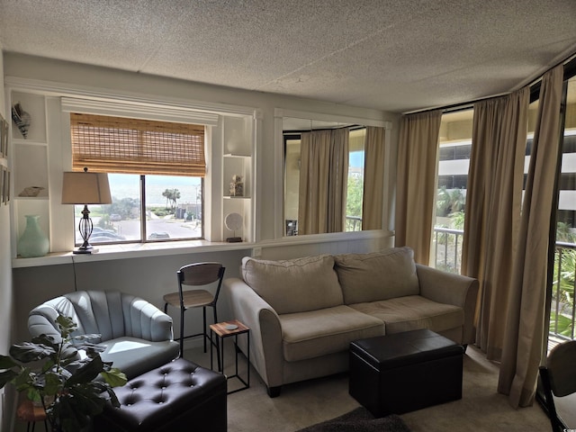 carpeted living room featuring a textured ceiling