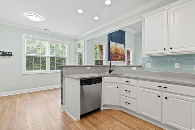 kitchen featuring white cabinets, stainless steel dishwasher, and light countertops