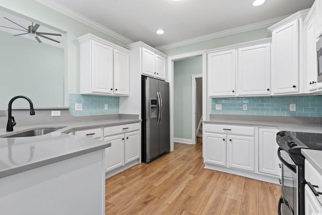 kitchen featuring light countertops, black electric range oven, white cabinets, a sink, and stainless steel fridge with ice dispenser