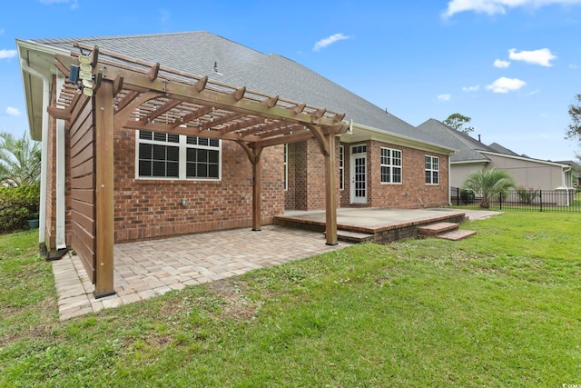 back of property featuring brick siding, fence, a yard, a pergola, and a patio area