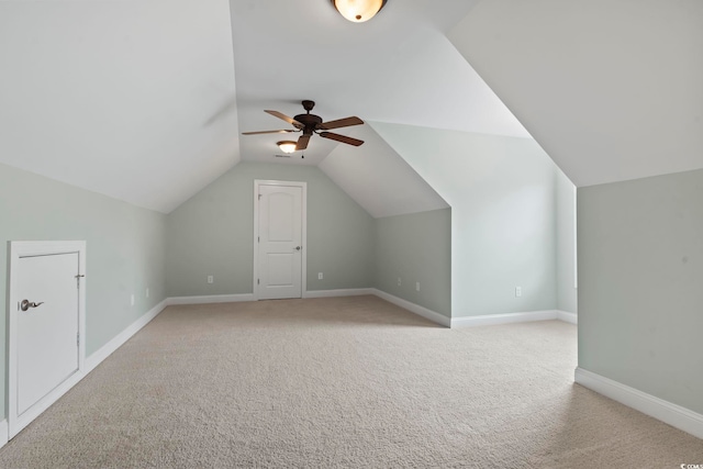 bonus room with lofted ceiling, baseboards, a ceiling fan, and light colored carpet