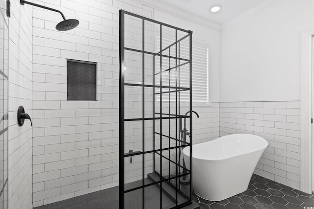 bathroom featuring tile patterned flooring, crown molding, a freestanding tub, a walk in shower, and tile walls