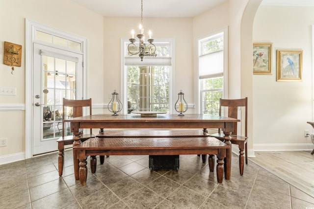 dining area featuring an inviting chandelier and hardwood / wood-style flooring