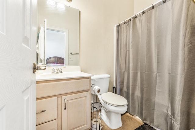 bathroom featuring vanity, tile patterned flooring, toilet, and curtained shower