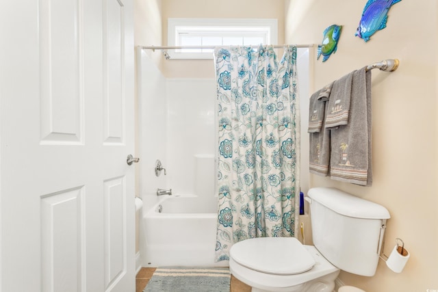 bathroom with shower / bath combo with shower curtain and toilet