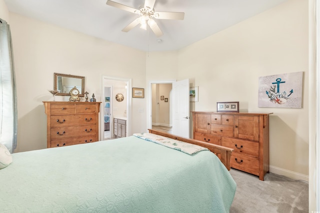 carpeted bedroom with ceiling fan and connected bathroom