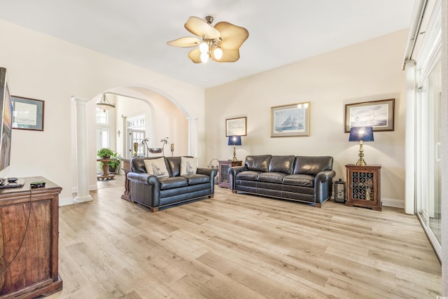 living room featuring ceiling fan, light hardwood / wood-style flooring, and decorative columns