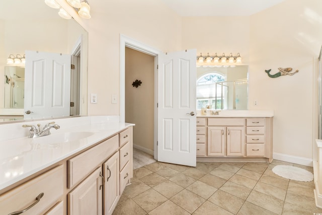 bathroom with vanity, a shower with shower door, and tile patterned floors