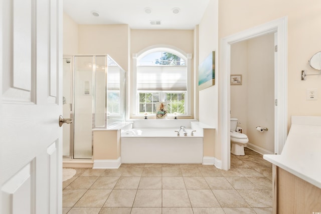 bathroom with plus walk in shower, tile patterned flooring, and toilet