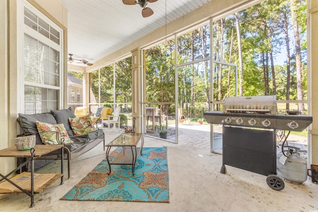 sunroom with ceiling fan and a wealth of natural light