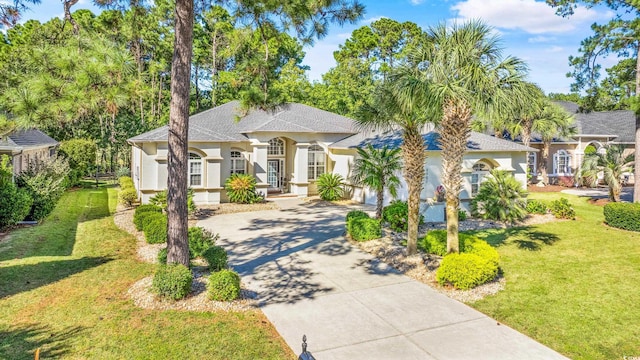 mediterranean / spanish home with a garage and a front yard