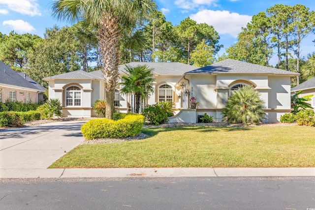 mediterranean / spanish house with a front yard