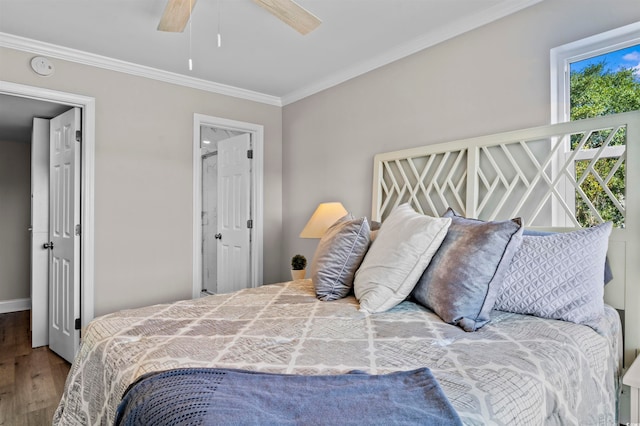 bedroom featuring crown molding, hardwood / wood-style flooring, and ceiling fan