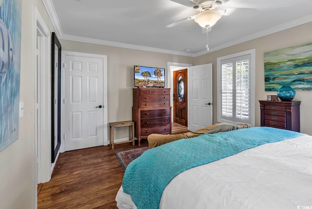 bedroom featuring dark wood-type flooring, ornamental molding, and ceiling fan