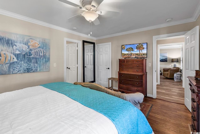 bedroom featuring ceiling fan, ornamental molding, and wood-type flooring