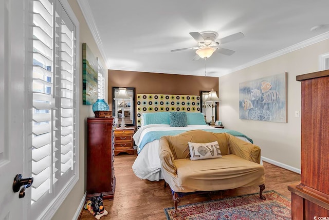 bedroom featuring crown molding, hardwood / wood-style floors, and ceiling fan