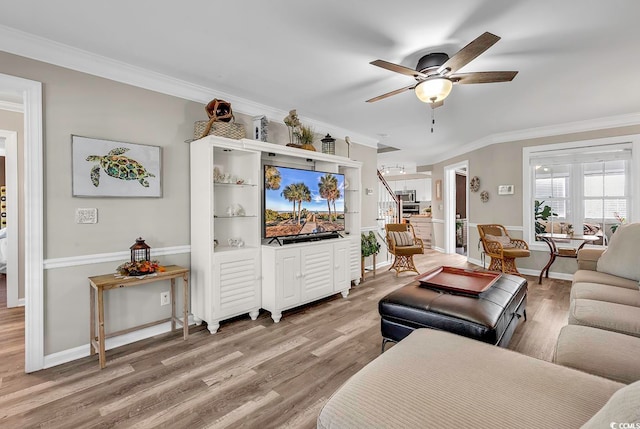 living room featuring ornamental molding, hardwood / wood-style flooring, and ceiling fan