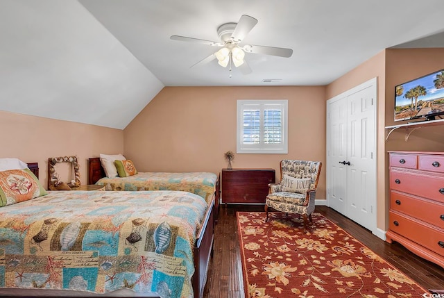 bedroom with a closet, vaulted ceiling, dark hardwood / wood-style flooring, and ceiling fan