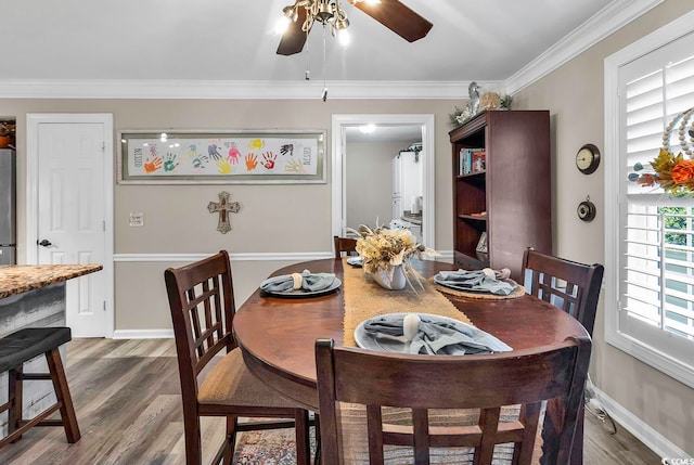 dining area featuring crown molding, ceiling fan, and hardwood / wood-style floors