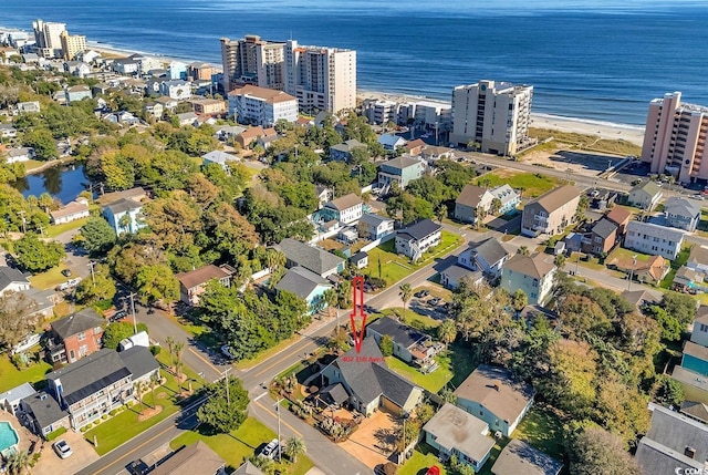 birds eye view of property featuring a water view and a view of the beach