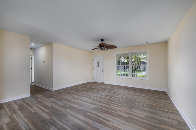 spare room featuring ceiling fan and dark wood-type flooring