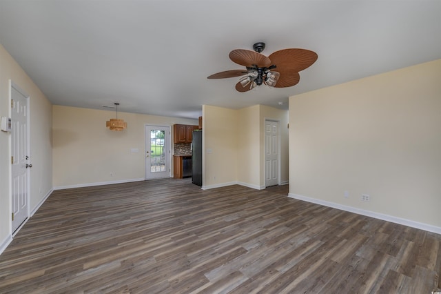 unfurnished living room featuring ceiling fan and dark hardwood / wood-style floors