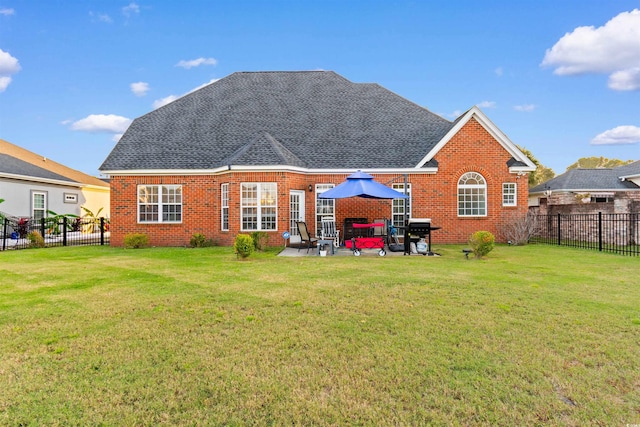 back of house with a patio and a lawn