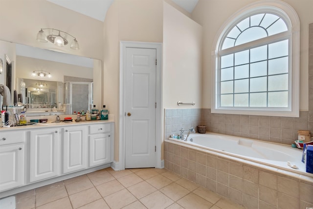 bathroom with vanity, tile patterned floors, vaulted ceiling, and separate shower and tub