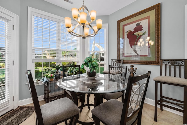 tiled dining space featuring an inviting chandelier and a wealth of natural light