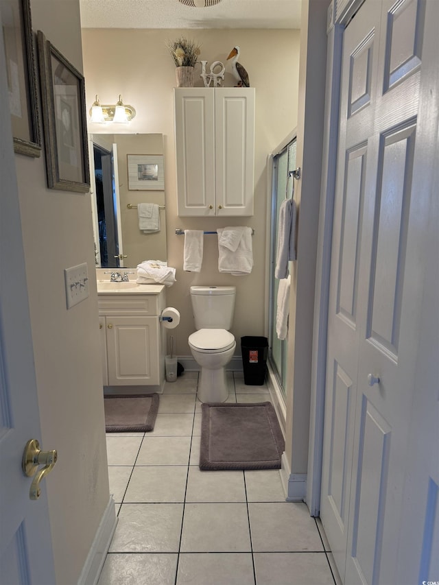 1538 Lanterns Rest Rd Unit 303, Myrtle Beach, SC 29579 - full bathroom with tile patterned floors, vanity, toilet, a shower stall, and baseboards